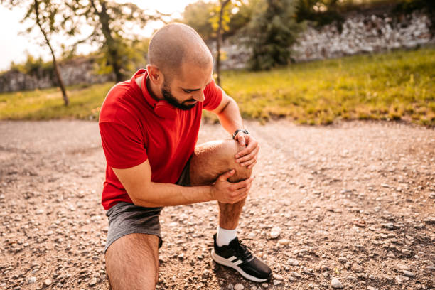 istock Sportsman hurting his knee during running 1330679848