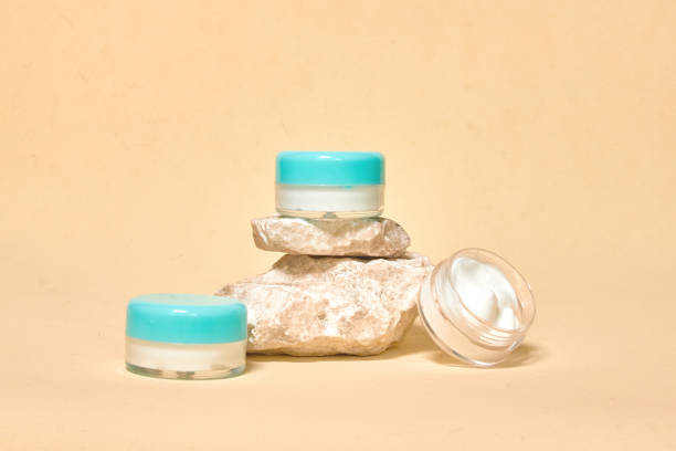istock Cosmetics container on the pastel background. Natural stones. Earth colors, zero waste containers. Mockup concept.  Copy space for text or design. Can be used as advert banner. 1330679900