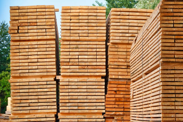 Stack of wood in lumber yard or construction site Stack of wood in lumber yard or construction site woodpile stock pictures, royalty-free photos & images