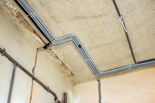 istock Electrical cables laid in protective corrugation installed on the ceiling and wall in a room under construction works. 1330680138