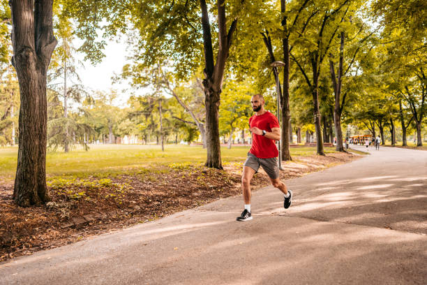 istock Athlete man running in public park 1330682083