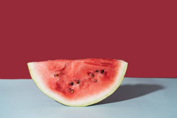 istock Piece of ripe watermelon against red background 1330683142