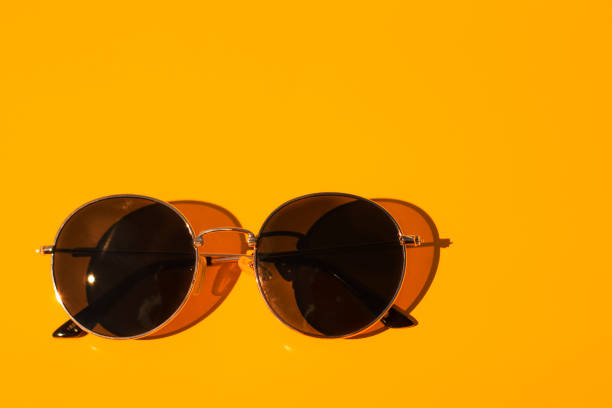 istock Sunglasses on a yellow background. 1330684439