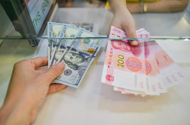 Exchange money, Exchange US dollar or American dollars (USD) for Chinese money or Renminbi (RNB) stock photo