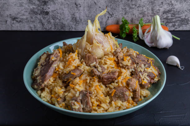 istock Uzbek national rice dish plov prepared on plate. 1330686806