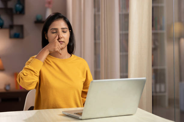 istock Young woman meditating practicing yoga while working at home 1330687166