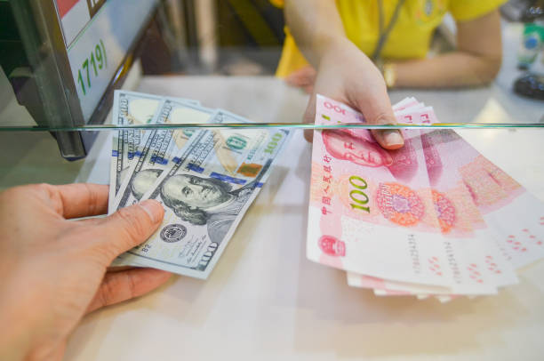 Exchange money, Exchange US dollar or American dollars (USD) for Chinese money or Renminbi (RNB) stock photo