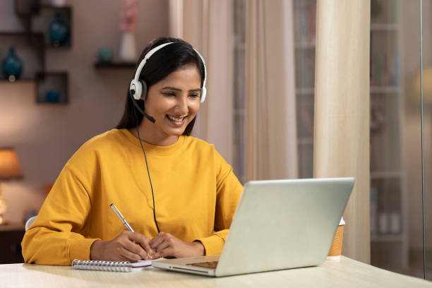 istock Shot of a young women telemarketer and IT support worker using laptop with headset working at home 1330688362