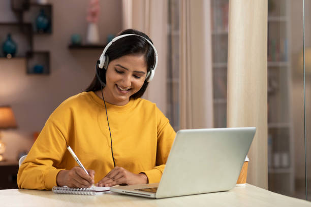 istock Shot of a young women telemarketer and IT support worker using laptop with headset working at home 1330688381