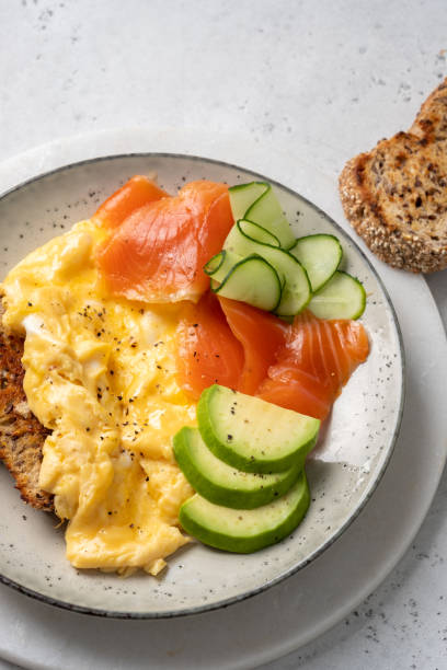 istock Ketogenic diet breakfast, scrambled eggs, salmon, avocado, spinach, top view. 1330691088