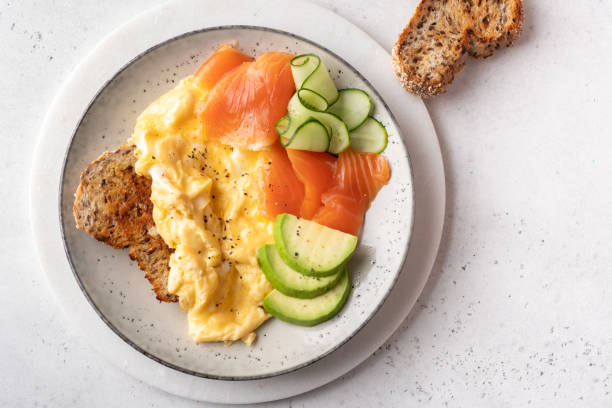 istock Ketogenic diet breakfast, scrambled eggs, salmon, avocado, spinach, top view. 1330691158