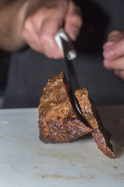 istock hump steak in an aluminum bowl with broth falling on top and copy space 1330691691