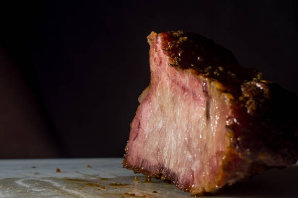 hump steak in an aluminum bowl with broth falling on top and copy space