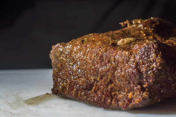 istock hump steak in an aluminum bowl with broth falling on top and copy space 1330691798