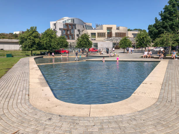 People enjoying the summer  at the pools at Scottish Parliament Building in Edinburgh, Scotland stock photo