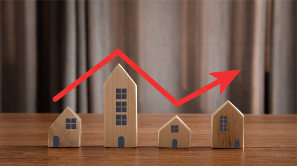 Close up of house model with red arrow pointing up same as step stair go up. concept real estate or property values growth up, Housing price increasing or rising market, investment buying and selling. stock photo