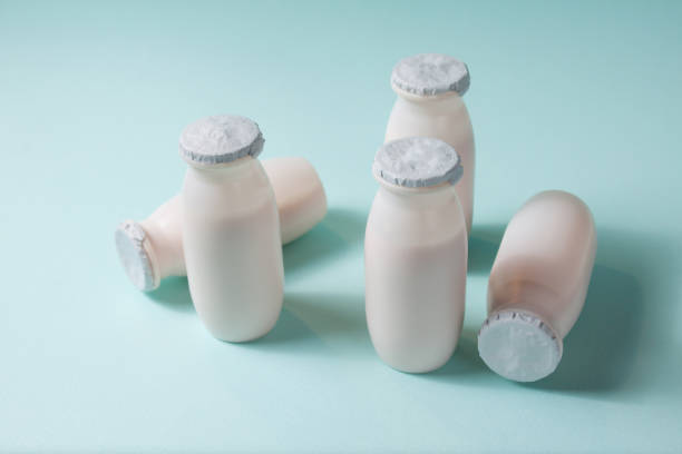 istock Bottles with probiotics and prebiotics dairy drink on light blue background. 1330697529