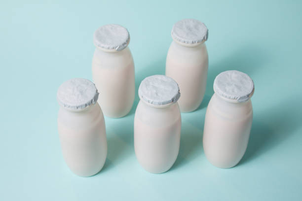 istock Bottles with probiotics and prebiotics dairy drink on light blue background. 1330697718