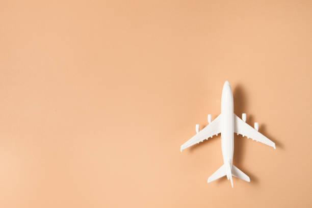 istock Flat lay design of travel concept with plane on brown background. 1330698024