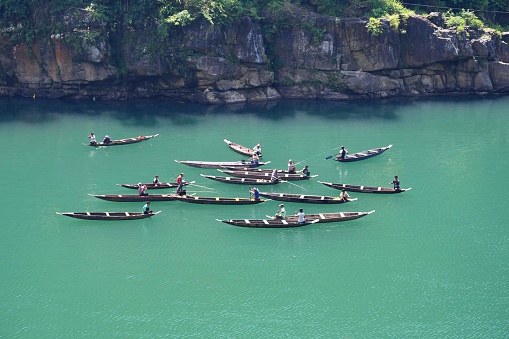 Fishermen at Dawki River Meghalaya, India. River has crystal clear water in a lush environment and is a popular place for boating and kayaking