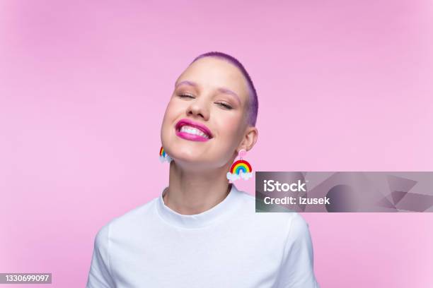 Headshot Of Woman With Short Purple Hair And Rainbow Earrings Stock Photo - Download Image Now