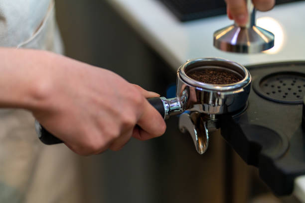 istock Asian man barista making hot coffee in a coffee maker 1330699429