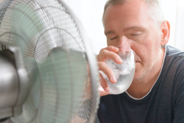 istock Man suffers from heat at home 1330700138
