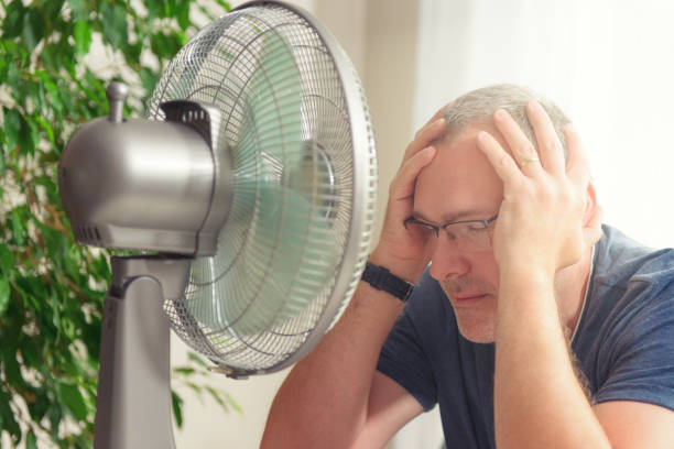 istock Man suffers from heat at home 1330700195