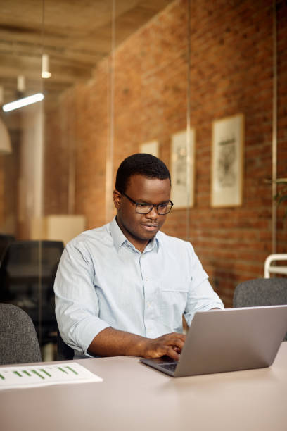 istock African American businessman using laptop while working in the office. 1330704011