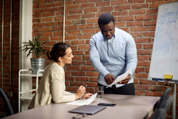 istock Multi-ethnic coworkers going through business plans during the presentation at corporate office. 1330704257