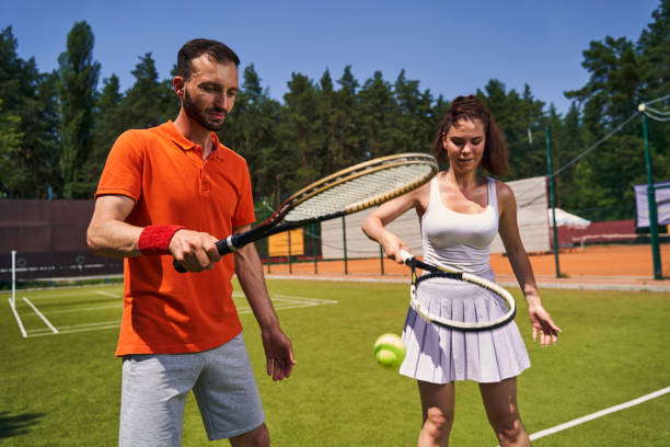 istock Two attractive tennis players focused on their training session 1330704315