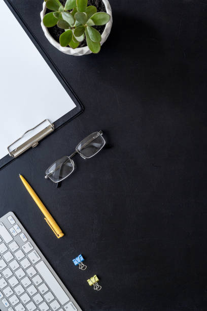 istock Top view of working place with computer keyboard and notepad 1330704722