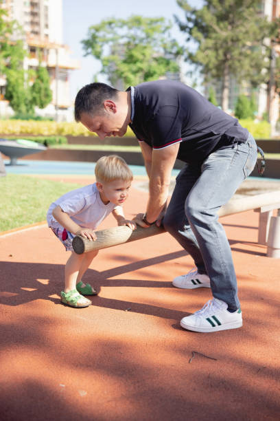 istock Father playing with son in jungle gym 1330706088