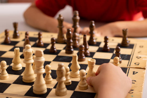 istock Kids playing chess at table, tournament between children 1330706159