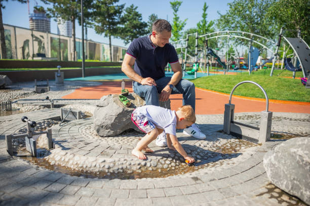 istock Smiling father watching his child playing 1330706894