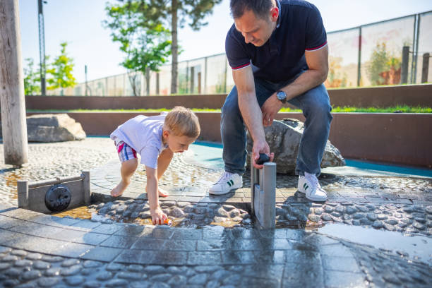 istock Father is playing with son in park 1330706895