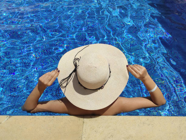 istock Woman relaxing in the swimming pool 1330707086