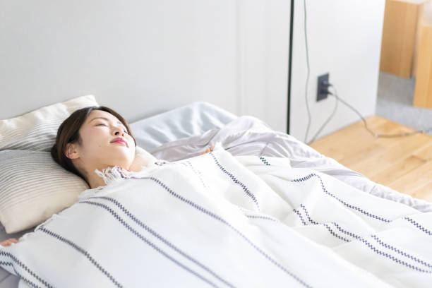 istock Young woman sleeping soundly in bed 1330707523