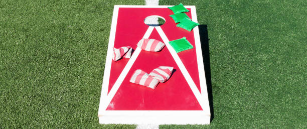 istock Front view of red and white cornhole game with bean bags on top 1330708255