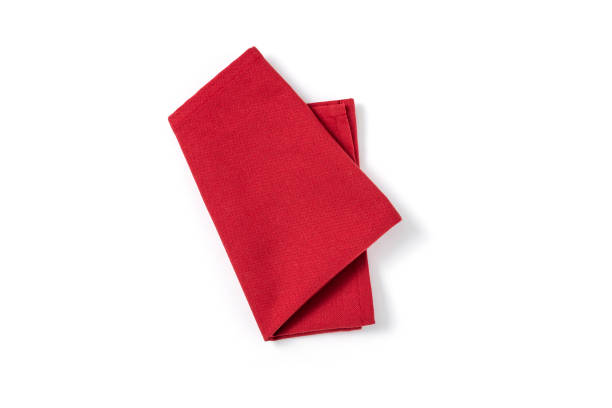 Red textile napkin isolated on white background. Red textile napkin isolated on white background. Folded decorative kitchen cotton towel. Top view napkin stock pictures, royalty-free photos & images