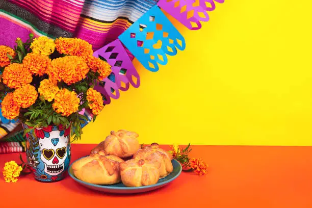 Day of the dead, Dia De Los Muertos Celebration Background With Skull, calaverita vase, marigolds or cempasuchil flowers, bread of death or Pan de Muerto with Copy Space. Traditional Mexican culture