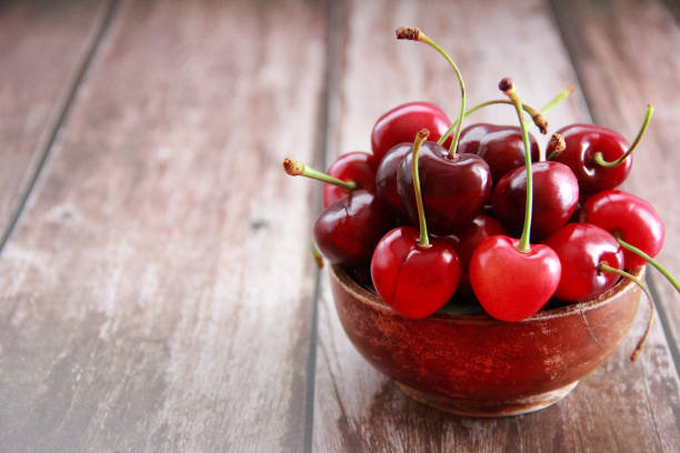 istock natural red cherry with a green stalk 1330710901