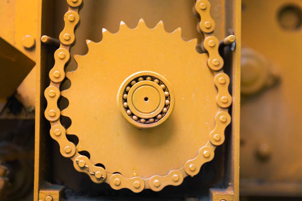 Closeup of orange gearwheel, part of the machine