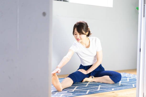 istock Young woman doing yoga at home 1330713773
