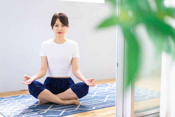 istock Young woman doing yoga at home 1330713820