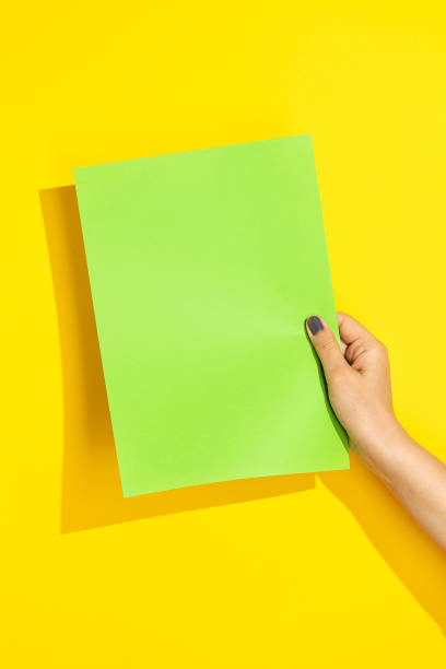 istock Hand holding green paper mockup 1330713918