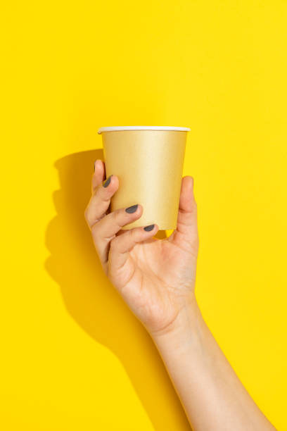 istock Hand holding disposable paper cup 1330715340