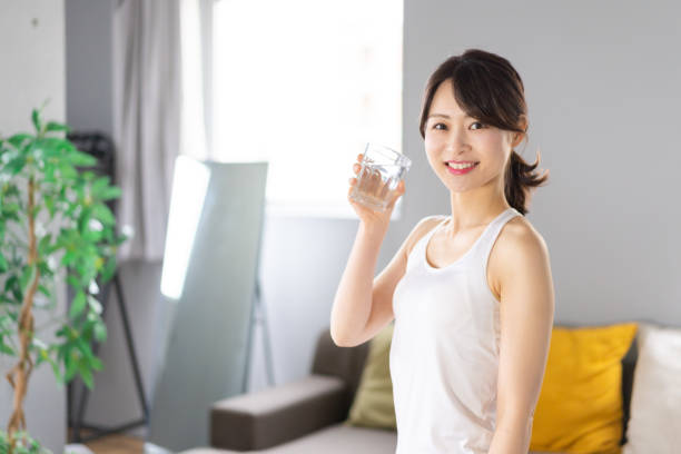 istock Young woman hydrating at home 1330716617