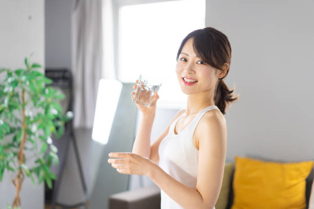 istock Young woman hydrating at home 1330716627