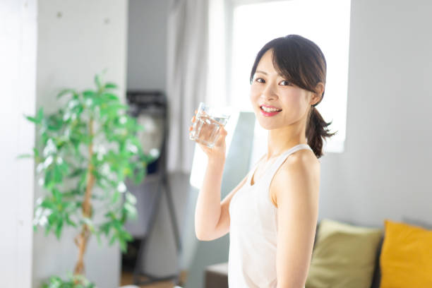 istock Young woman hydrating at home 1330716651